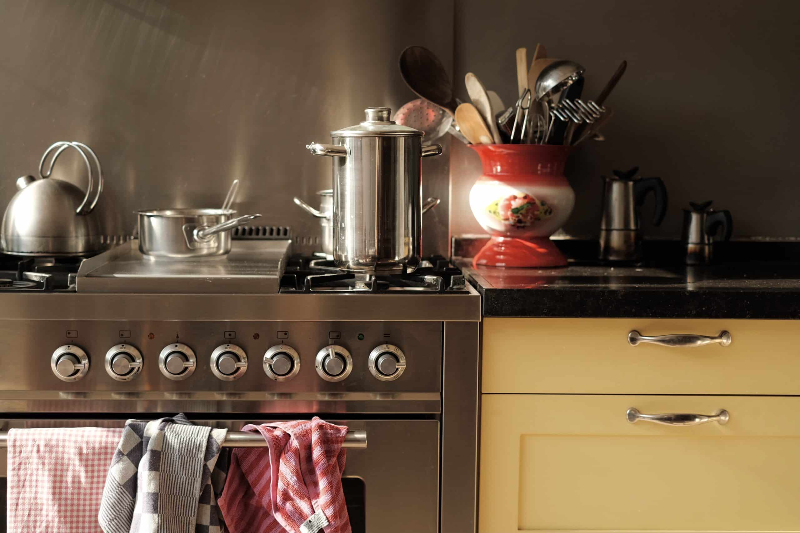 yellow-kitchen-and-stainless-steel-stove-with-pots-2021-09-02-14-42-09-utc